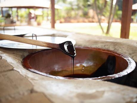 Molasses is fermented with yeast and distilled to produce Kill-Devil, the first version of rum.